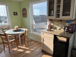 Enjoy meals with a view from this kitchen, featuring a dishwasher and dining area.
