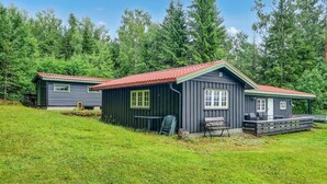 Two cabins with red roofs, wooden decks, and a grassy area in front. - Nice home in Sagstua with lake view (Sagstua)