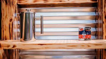A stainless steel pot on a wooden shelf with a can of Morton Kosher Salt & Pepper beside it.