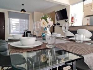 Enjoy meals in style with a glass dining table and comfortable seating.