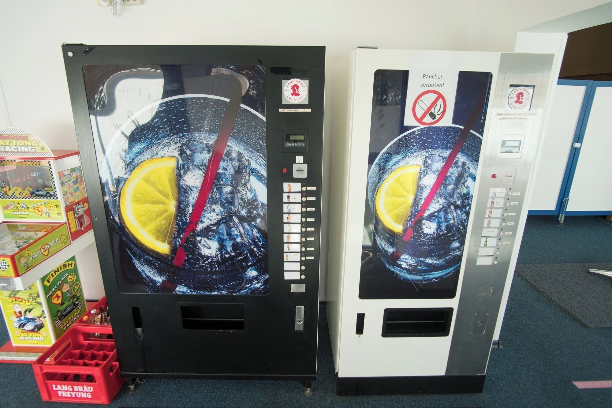 Two vending machines with a beverage dispenser and a selection panel.