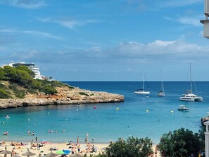 A coastal beach with clear blue waters, a rocky shoreline, and several yachts anchored nearby. - CalaMarcal on the Beach with Mediterranean Sea View!  BOOK YOUR SPRING VACATION! (Panta Dcha #5)