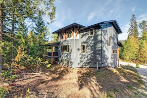A modern two-story house with a deck, surrounded by trees. - Fernie Alpine Chalet (Fernie)