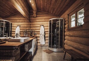 A log cabin bathroom with a wooden interior, a glass shower enclosure, and a large mirror. - Fjordhygge, Cozy Log Retreat Near Sea & Forest - Sauna & Outdoor Living (Jægerspris)