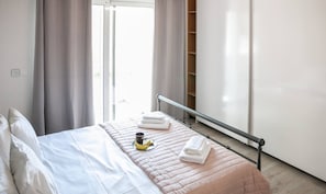 Enjoy a restful stay in this stylish room with a neatly made bed, wardrobe, and simple breakfast setup.