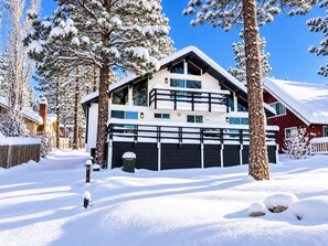 A multi-story house with a garage, surrounded by snow-covered trees. - Big Bear Lake View (Big Bear Lake)