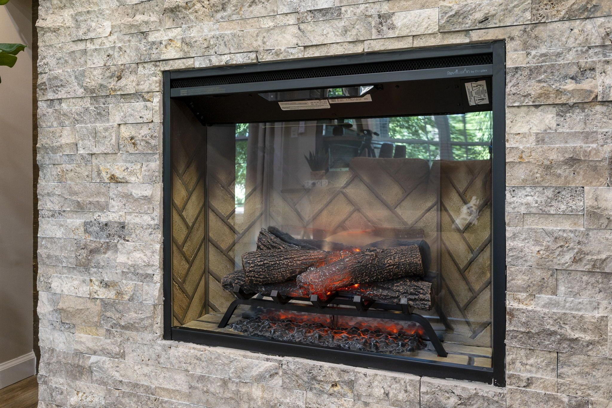 A stone wall with a fireplace.