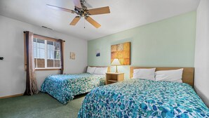 A room with two beds, a ceiling fan, a window with curtains, and a wall-mounted lamp. - Cozy Fox Cabin (Big Bear Lake)