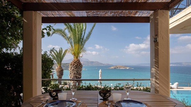 A table set for two with a view of the sea and mountains. - Luxury Seaview Apartment, 1min Walk From Beach! (Apokoronas)