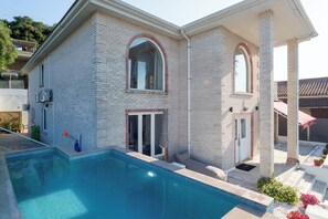 A two-story house with a swimming pool, a covered patio, and a brick exterior. - Villa Kostamaria, spacious 5 Bed, 3Ba, Sea view, private pool (petriti)