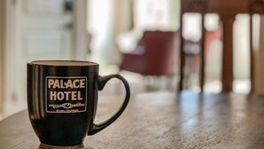 A black mug with "PALACE HOTEL" and "SALIDA, COLORADO" text on a wooden table. - Dog Friendly- Downtown - Historic Palace Hotel Condos- Suite 202 (Salida)