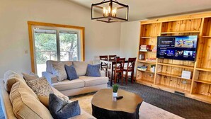 A cozy living room with a sofa, coffee table, and TV. - Timber Terrace - .9 mi Downtown *pet friendly (Prescott)