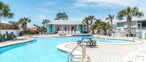A swimming pool with lounge chairs and a gazebo.
