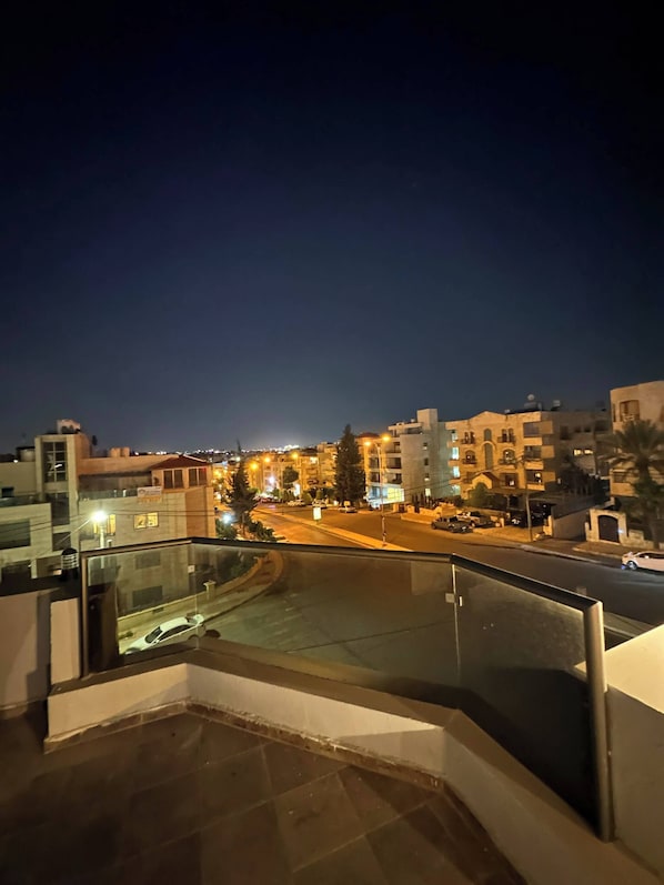 Enjoy breathtaking views of the city skyline from this balcony.