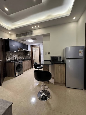 Enjoy cooking in this well-equipped kitchen with a central island, stainless steel appliances, and an oven.