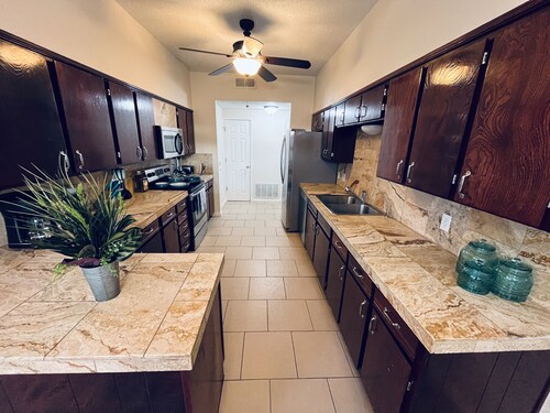 Chic brick interior condo lit by string lights