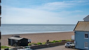 A beach view with a road, a small building, and a parked car. - Lyndhurst, Aldeburgh (Aldeburgh)