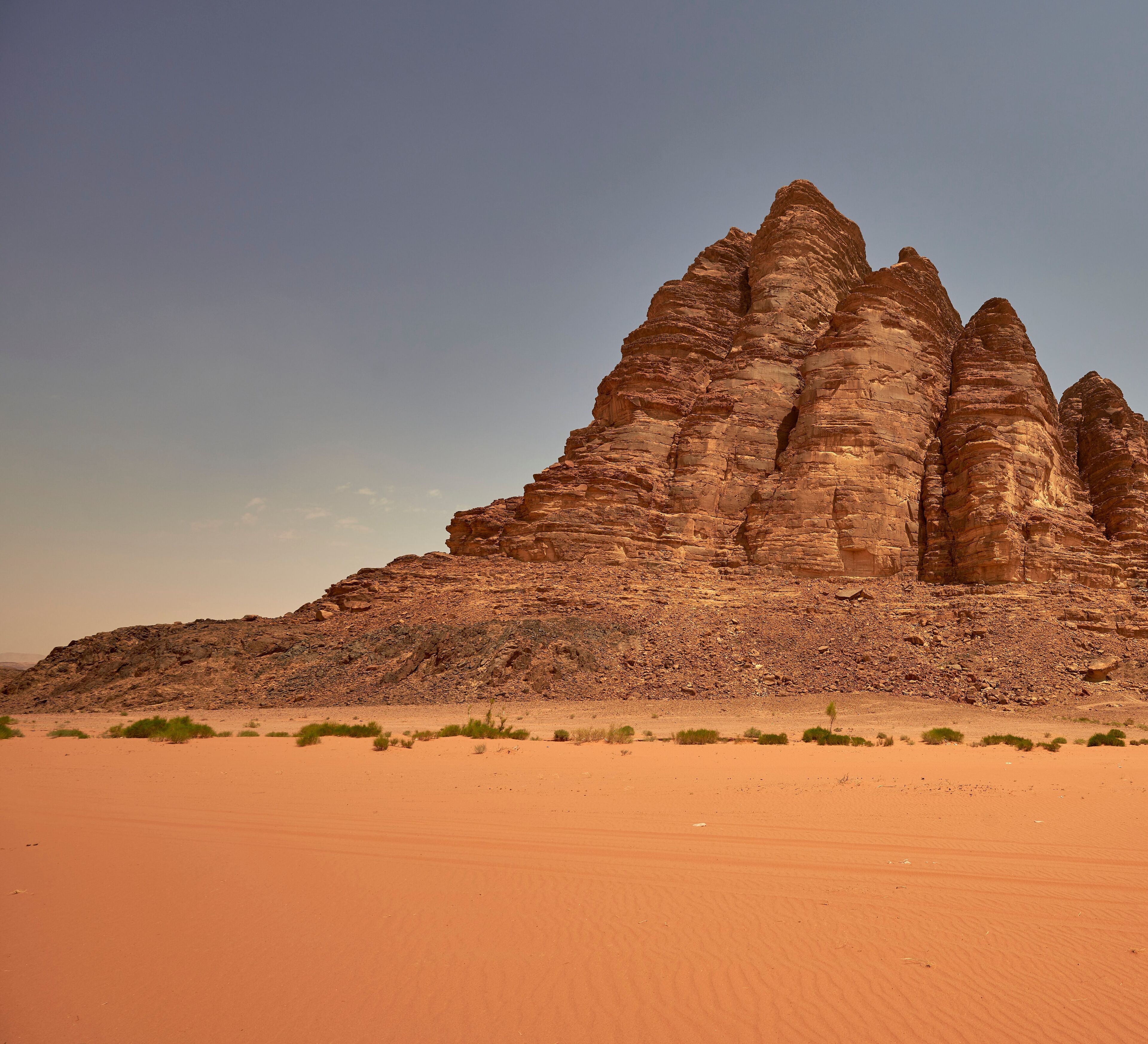 A desert landscape with a prominent rock formation.