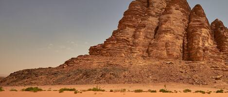 A desert landscape with a prominent rock formation.