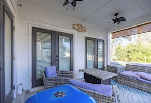A covered outdoor area with wicker furniture, a pool table, and a sign reading "Beach House". - 10 Beds sleeps 16 with Arcade GAME ROOM & POOL! (Orange Beach)