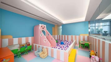 Children can play and relax in this spacious room with a colorful play structure, padded play zone, and toys.