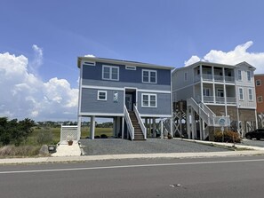 A two-story building with a balcony and a staircase leading to an upper level. - Sun-kissed Mermaid / 846 Ocean Blvd West 2 Bedroom Home by RedAwning (Supply)