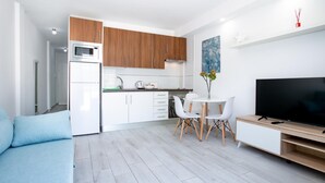 A modern apartment with a kitchen, dining area, and living room. - 475 B Island Village Sea View Pool & Terrace (Costa Adeje)