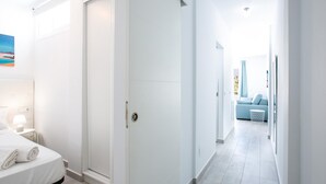 A modern hotel room with a bed, a nightstand, a desk, and a view of the sea. - 475 B Island Village Sea View Pool & Terrace (Costa Adeje)