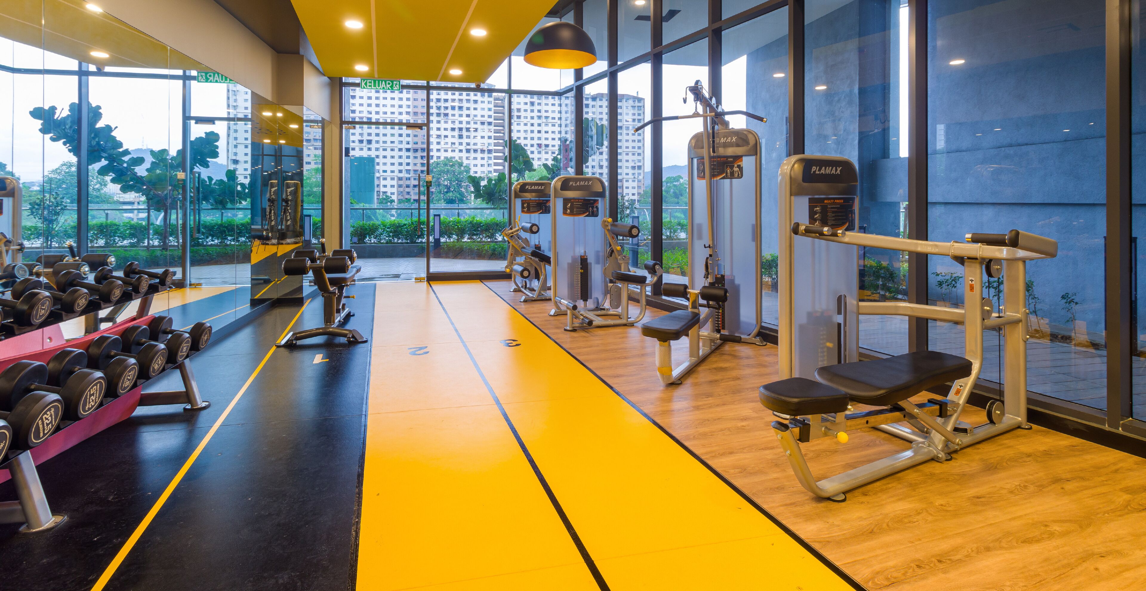 A gym with exercise equipment, a bench, and a dumbbell rack.