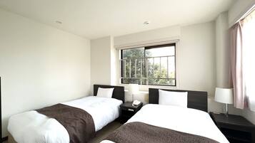 Desk, laptop workspace, bed sheets