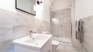 Shower, hair dryer, towels, shampoo