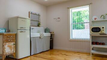 Fridge, microwave, coffee/tea maker, cookware/dishes/utensils