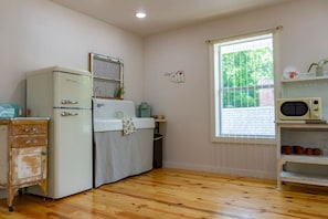 Fridge, microwave, coffee/tea maker, cookware/dishes/utensils