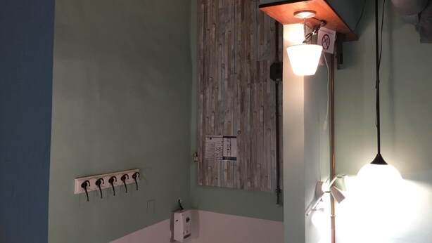 A room with a wooden wall panel, a white switchboard, and a wall-mounted light fixture. - Servi 39 in Firenze With 2 Bedrooms and 2 Bathrooms (Florence)
