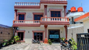 A two-story building with a balcony, a sign reading "JR Residence," and two motorcycles parked in front. - Hotel O Jr Residence Syariah (Medan)