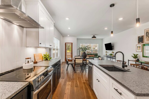 Enjoy cooking in this well-equipped kitchen with a central island, stove, and ample counter space.