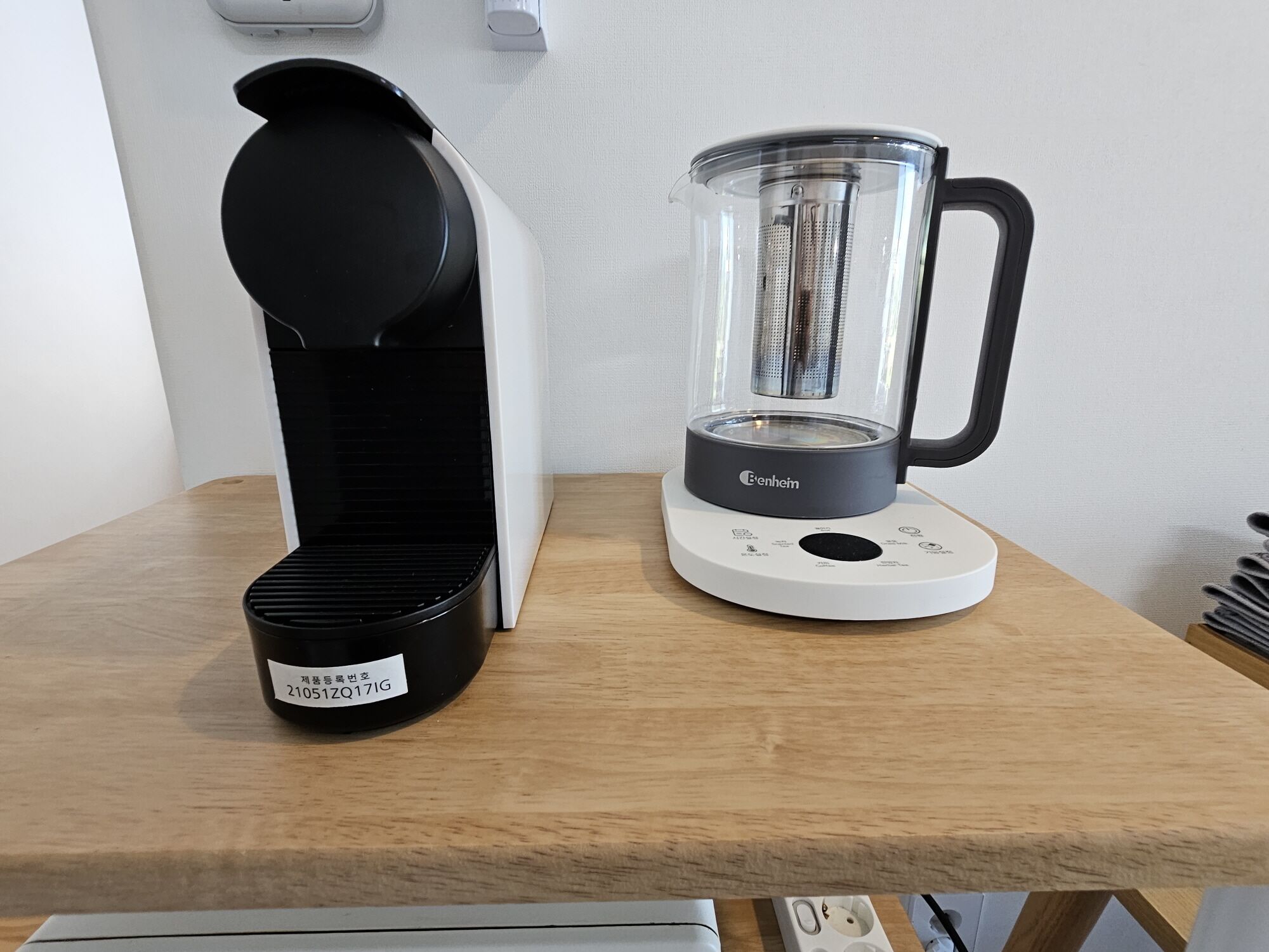 A kitchen with a coffee maker and a blender on a wooden countertop.