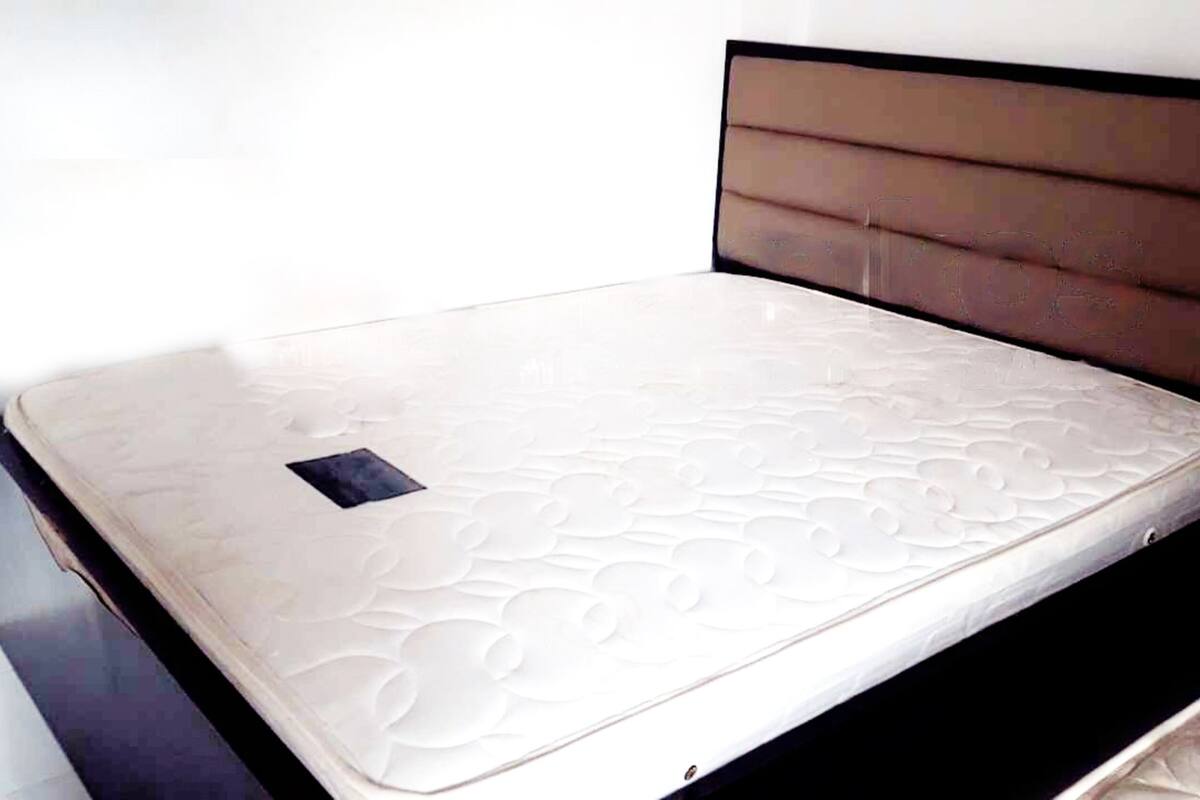 A bed with a mattress and a headboard.