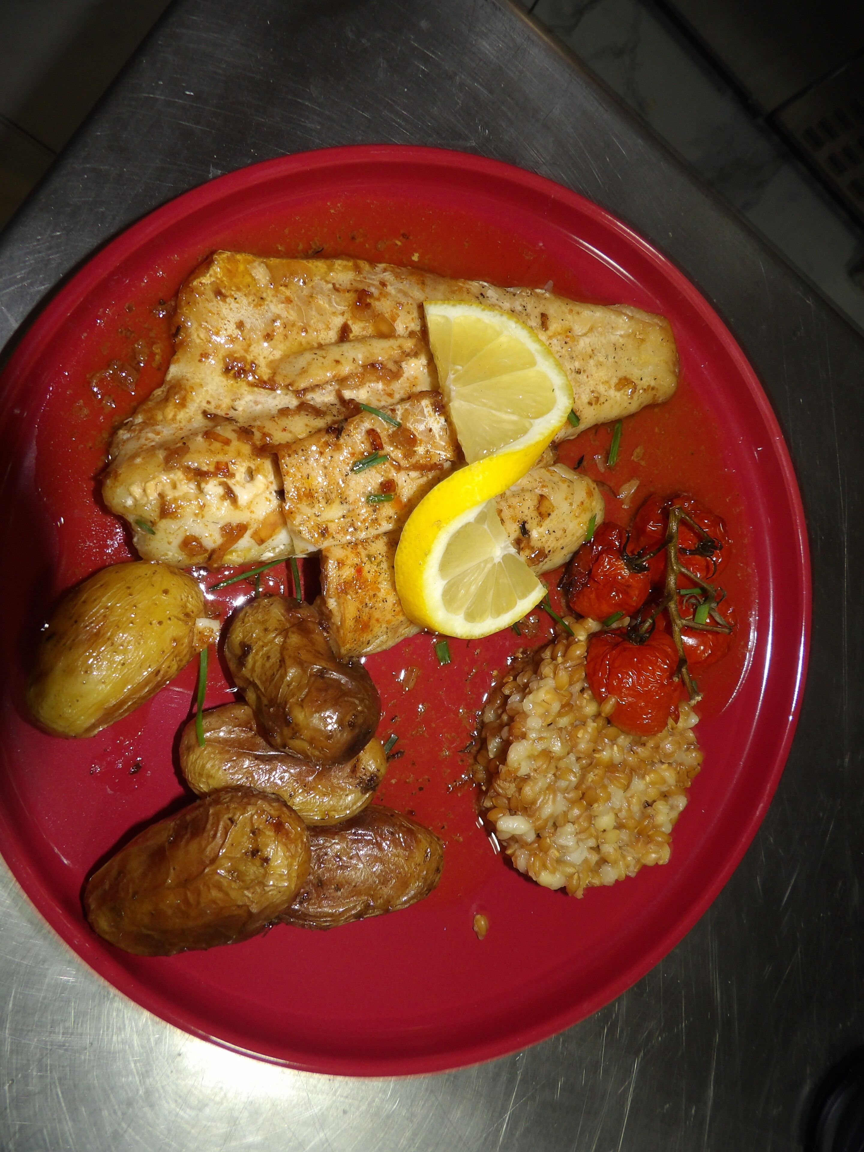 A plate of food with fish, potatoes, and rice.