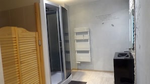 A bathroom with a shower, a toilet, and a sink.