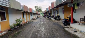 Residents walk through this charming alleyway lined with a mix of homes.