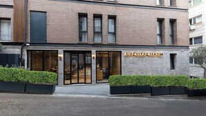 A modern building with a glass entrance and the name "AHG ATLAS TAKSIM" displayed above. - Ahg Atlas Hotel Taksim (Istanbul)