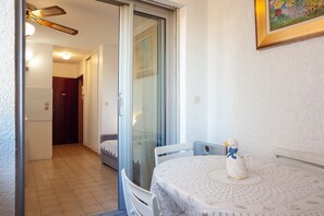 Una habitación con una mesa de comedor, sillas, una figura decorativa de un pingüino y un cuadro en la pared.