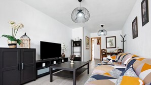 A modern living room with a sofa, TV, and decorative items. - Vacation Home 'Luha' with Private Terrace and Wi-Fi (Corralejo)