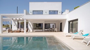 A modern house with a swimming pool, outdoor seating, and a covered patio. - "Alba Sea" Villa with Private Pool, 2 Private Terraces and Wi-Fi (Chiclana de la Frontera)