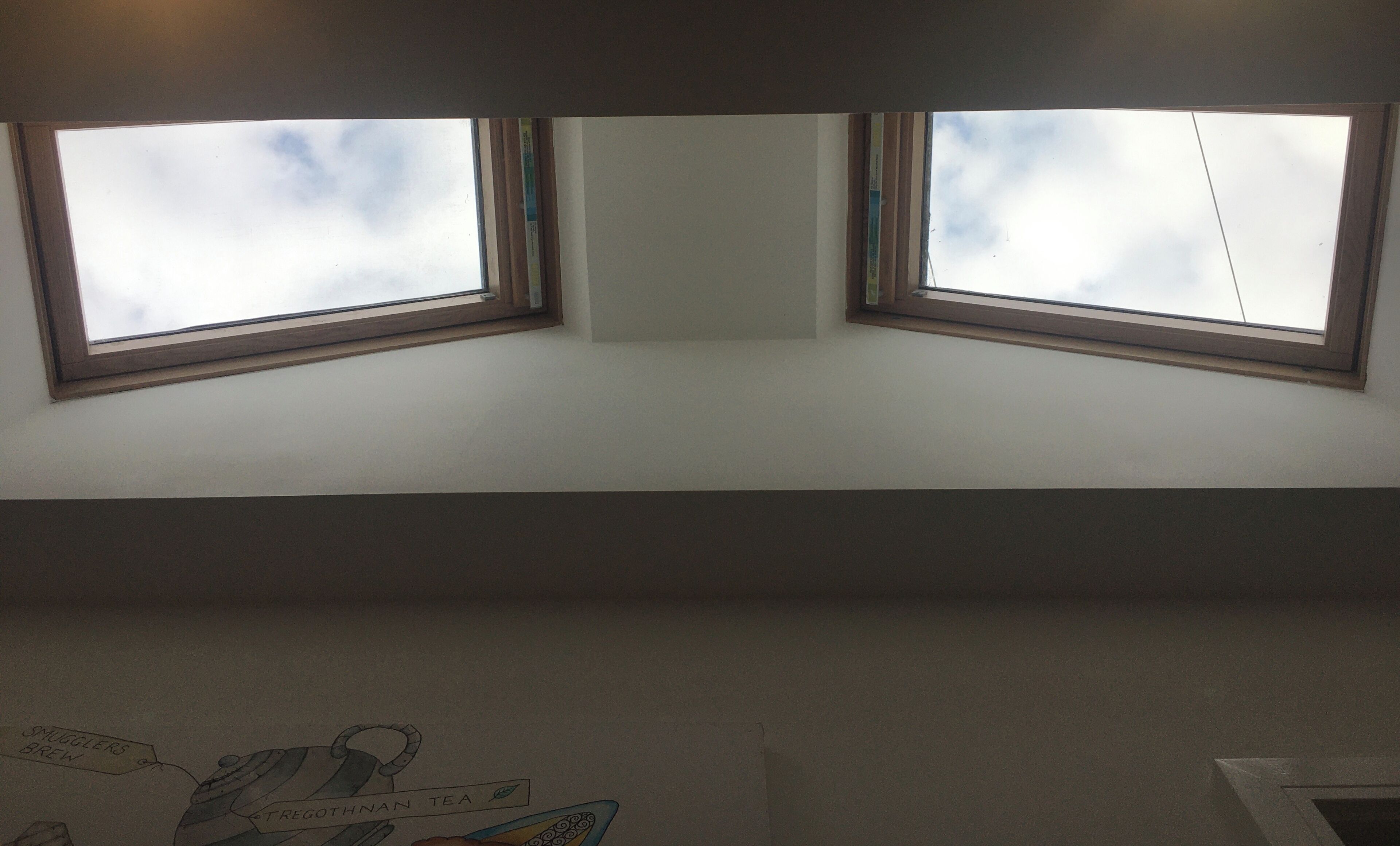 A room with two skylights allowing natural light.