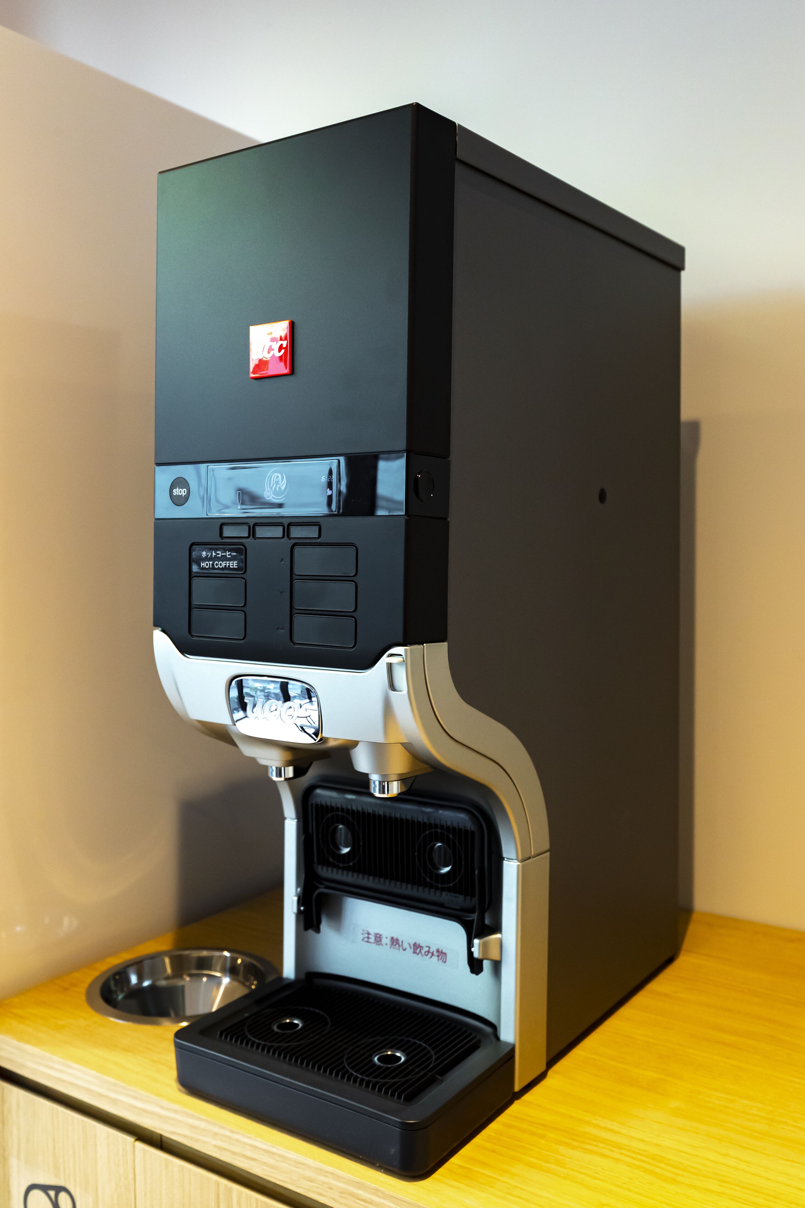 A coffee machine with a digital display and a water reservoir.