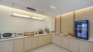 A modern kitchen with built-in appliances, a refrigerator, and a sink. - No.25 Hotel (Gwangju)