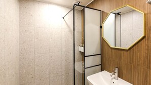 A bathroom with a shower, a sink, and a mirror. - No.25 Hotel (Gwangju)