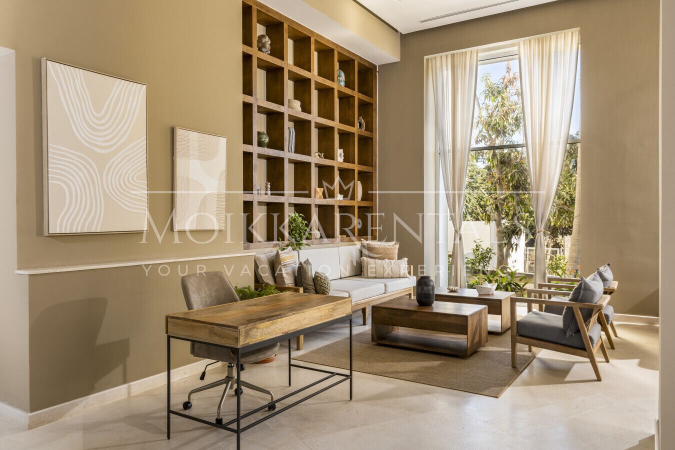 A spacious living room with a large window, a wooden bookshelf, a sofa, and a coffee table.